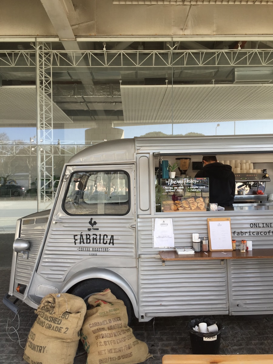 a silver food truck parked in front of a building